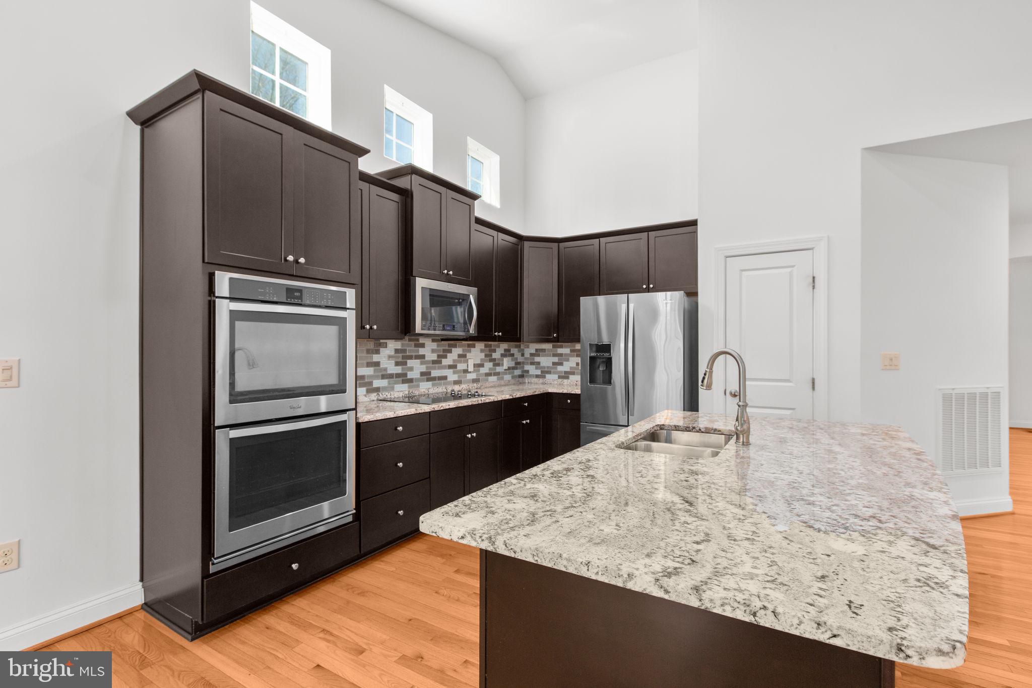 400 Telegraph Road Stafford, VA 22554 - Photo 11 of 79 a kitchen with stainless steel appliances granite countertop a sink refrigerator and microwave