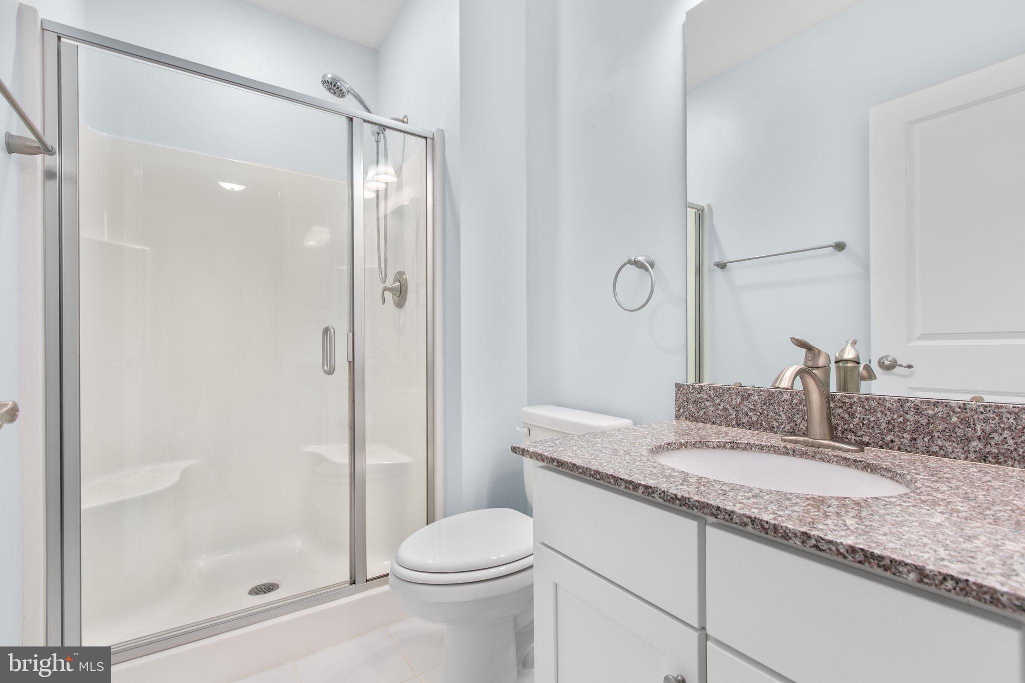 400 Telegraph Road Stafford, VA 22554 - Photo 23 of 79 a bathroom with a granite countertop sink a toilet and shower