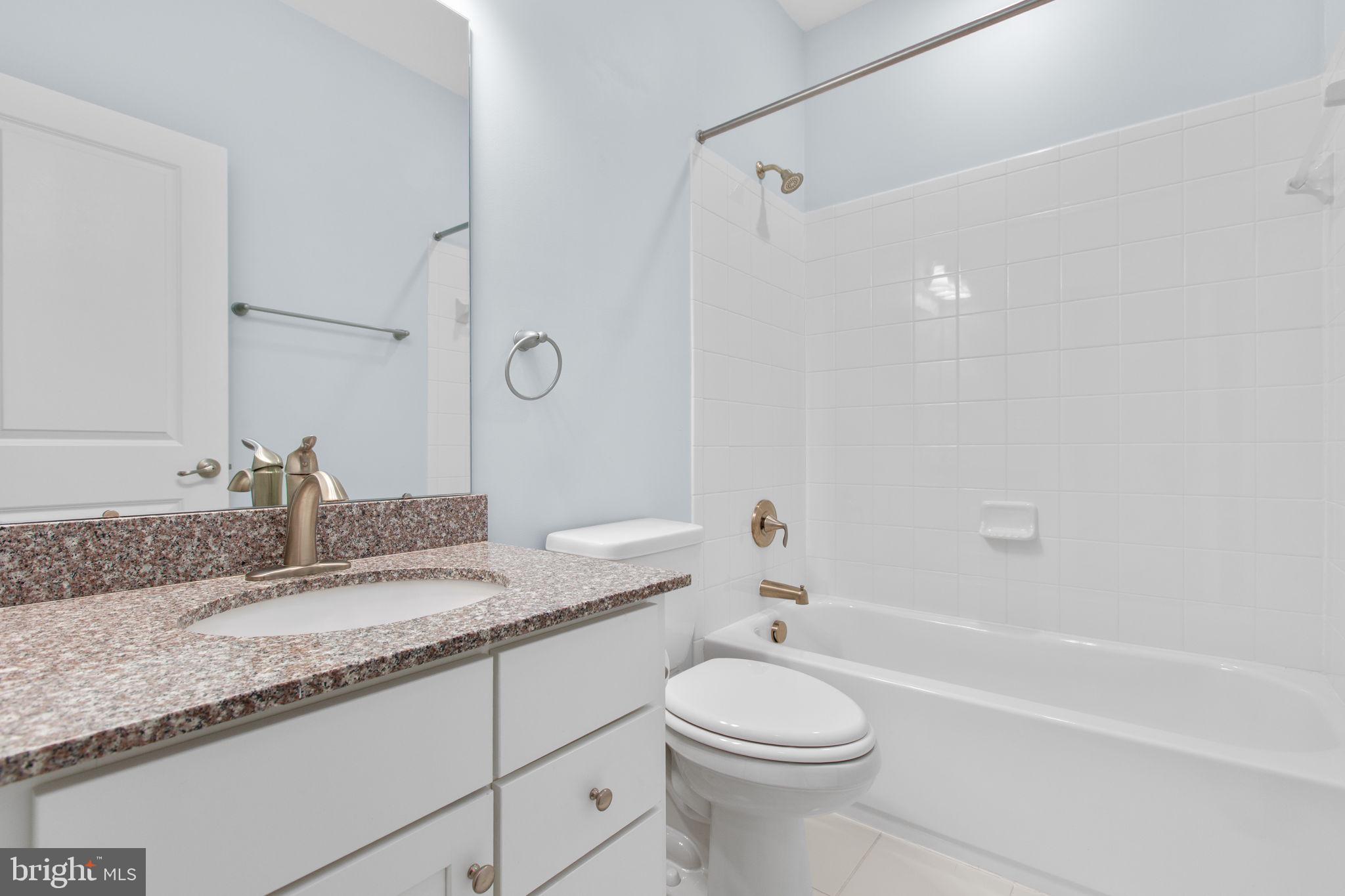 400 Telegraph Road Stafford, VA 22554 - Photo 30 of 79 a bathroom with a granite countertop sink toilet and shower