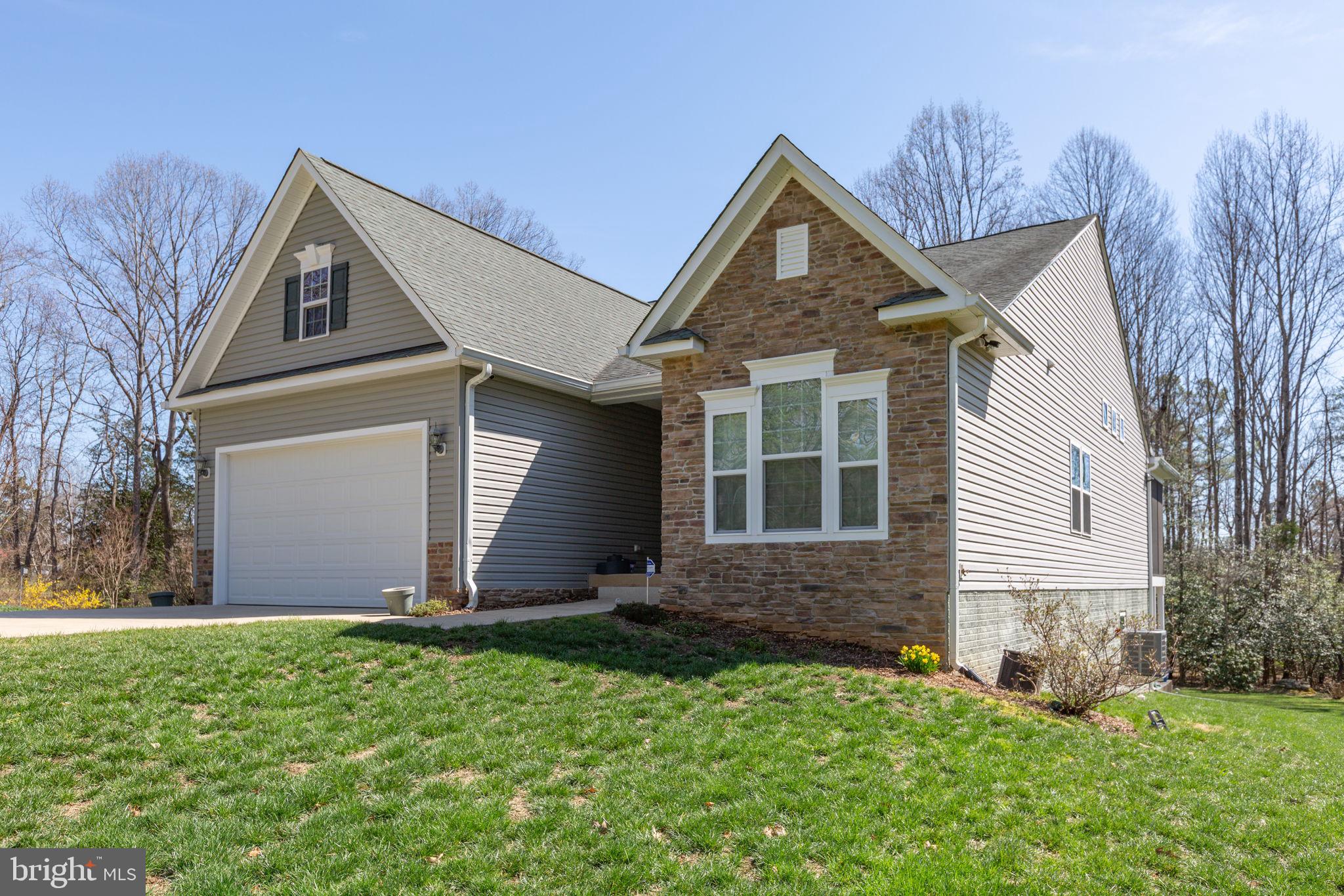 400 Telegraph Road Stafford, VA 22554 - Photo 4 of 79 a front view of a house with a yard and garage