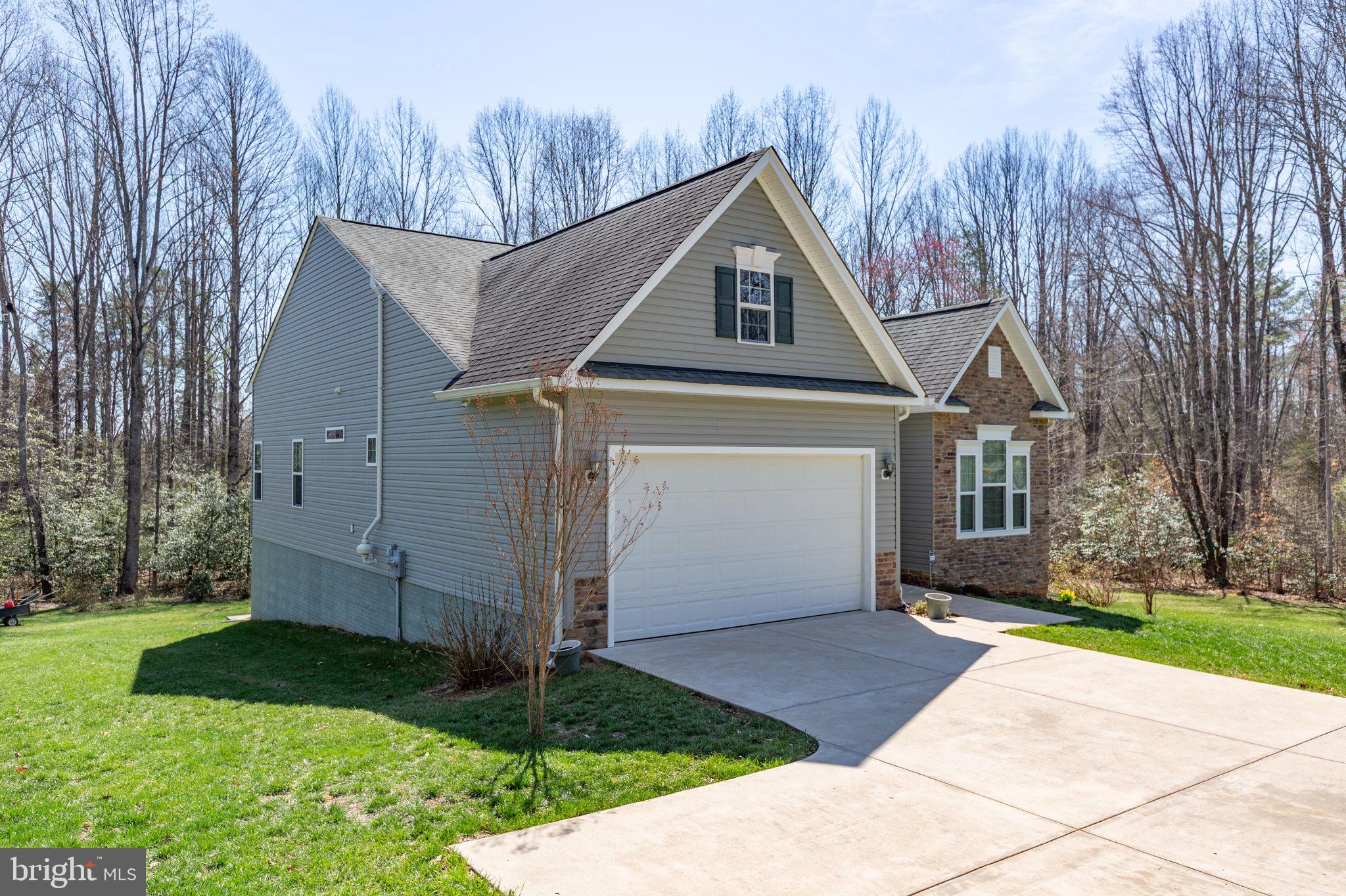 400 Telegraph Road Stafford, VA 22554 - Photo 5 of 79 a front view of a house with a yard and garage