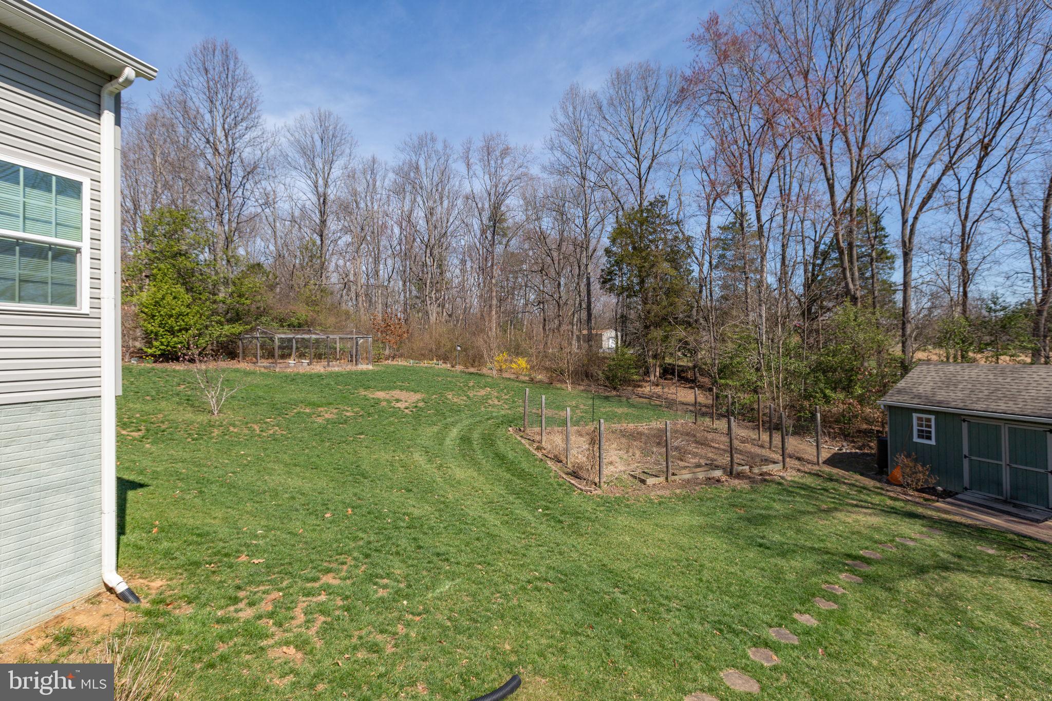400 Telegraph Road Stafford, VA 22554 - Photo 54 of 79 a view of a backyard with table and chairs potted plants and large tree