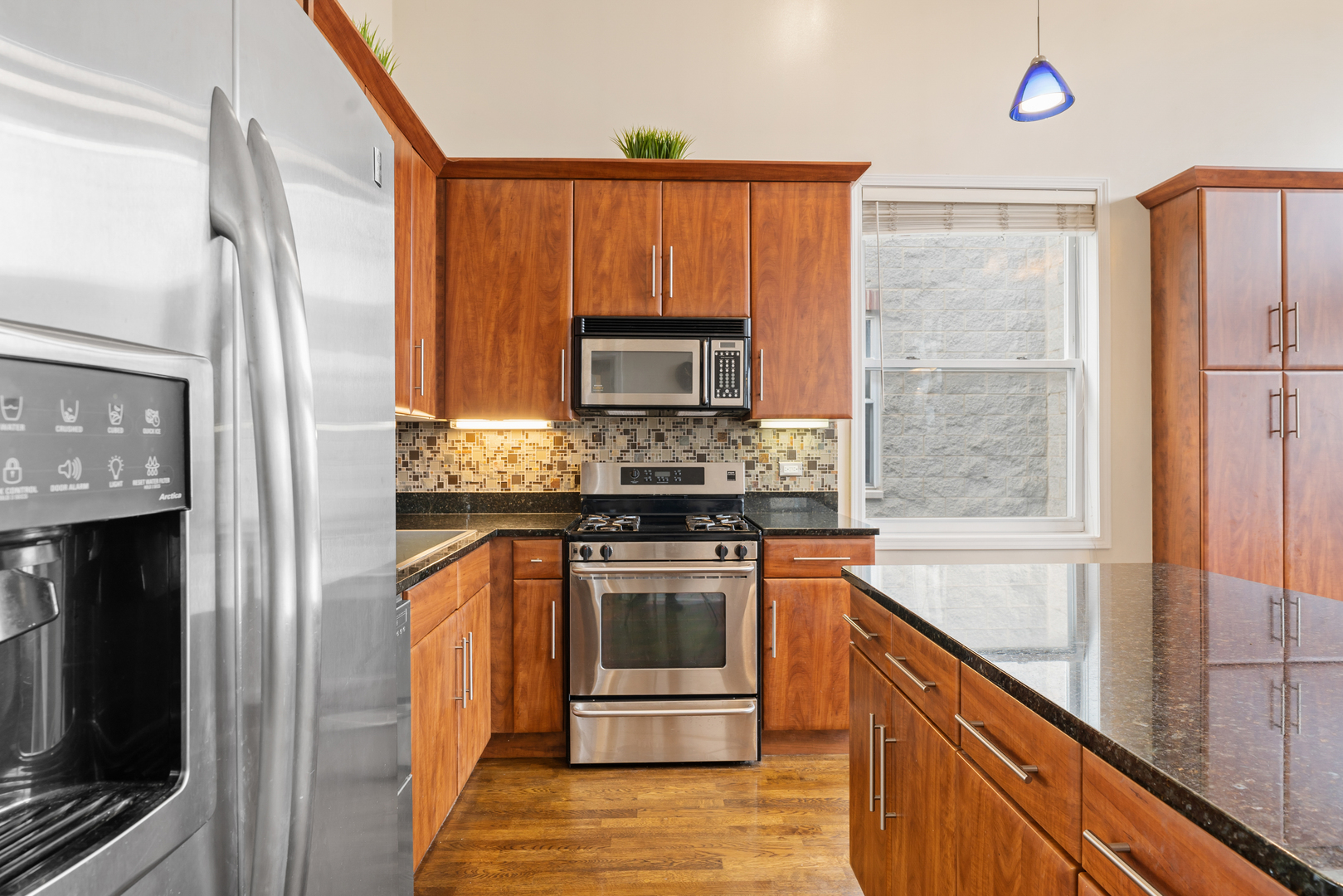2123 West Rice Street, Unit 4 Chicago, IL 60622 - Photo 8 of 26 a kitchen with stainless steel appliances granite countertop a stove a sink and a refrigerator