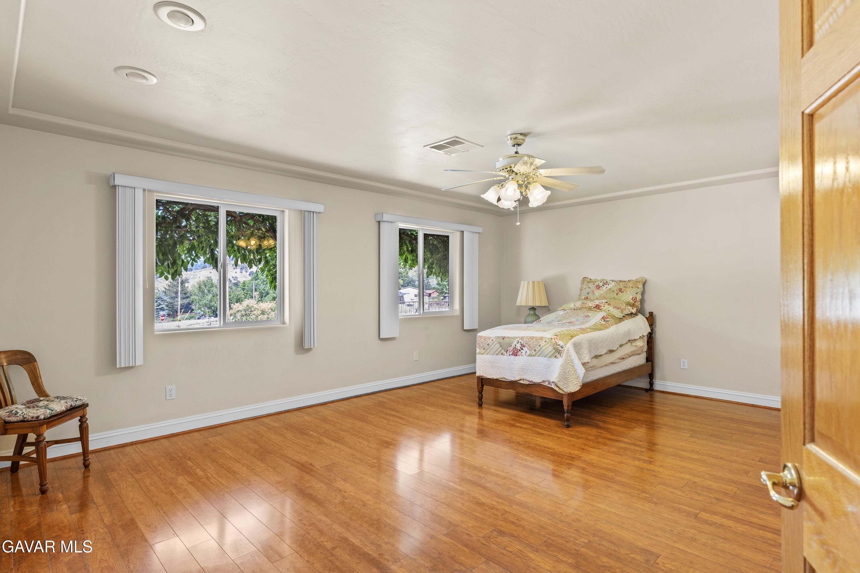 30100 Sunland Way Tehachapi, CA 93561 - Photo 22 of 44 a bedroom with a bed and a chandelier