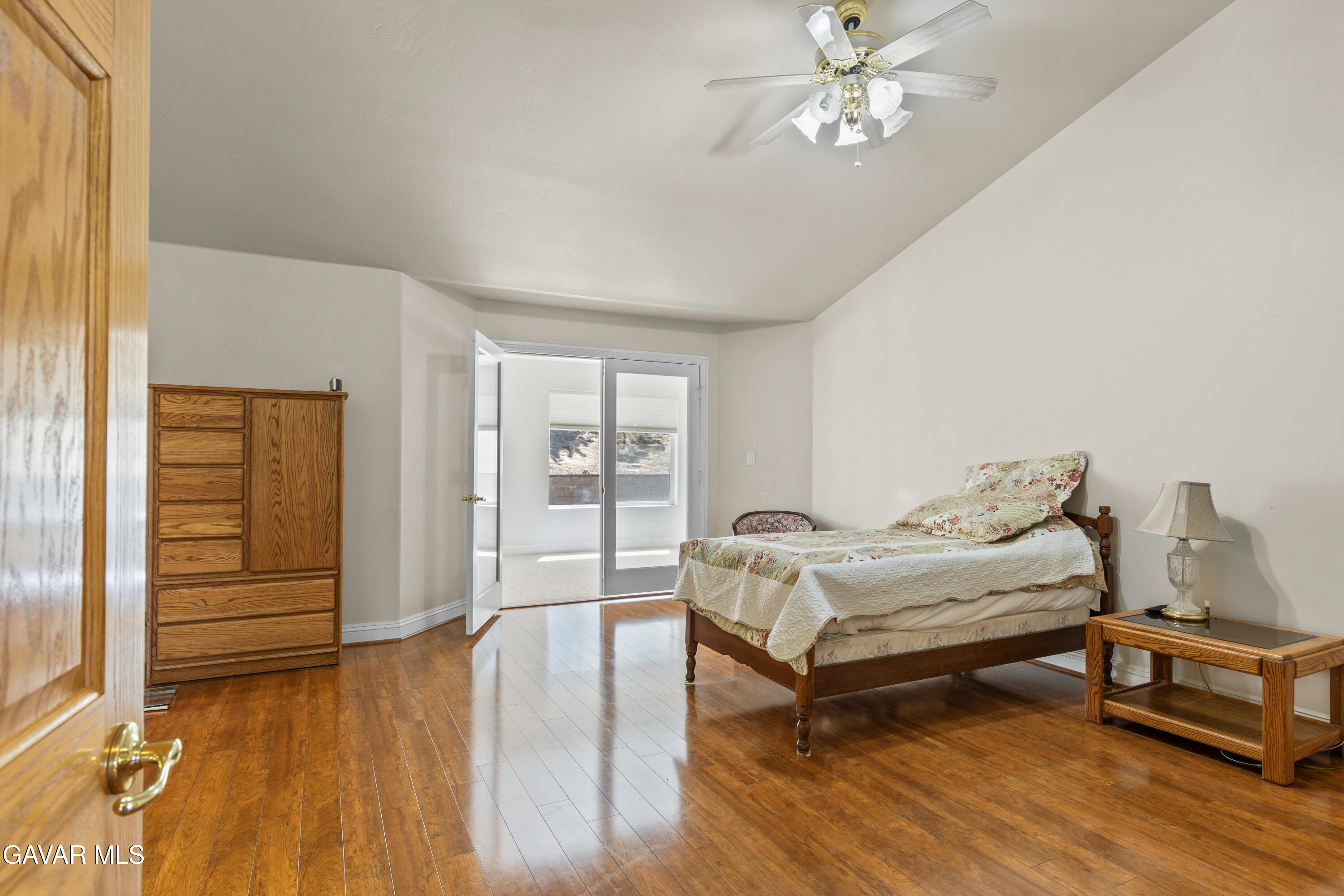 30100 Sunland Way Tehachapi, CA 93561 - Photo 25 of 44 a bedroom with a bed and wooden floor