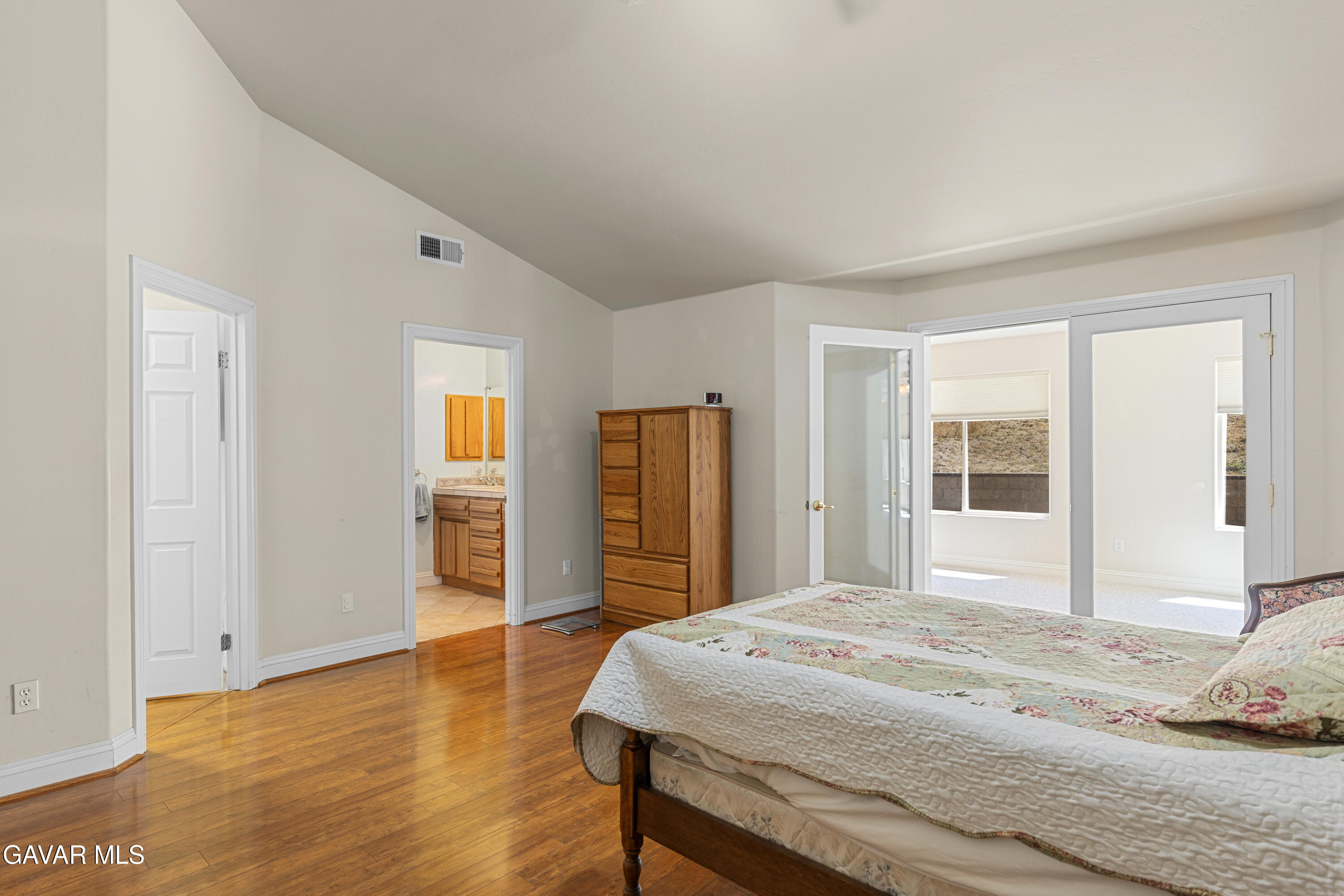 30100 Sunland Way Tehachapi, CA 93561 - Photo 26 of 44 a bedroom with a bed and wooden floor