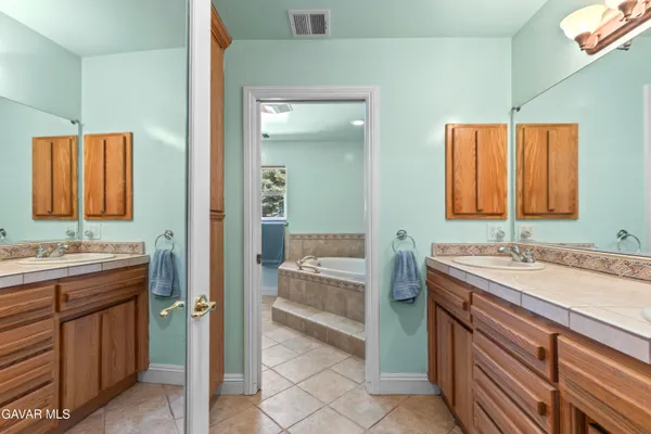 a bathroom with a sink a vanity and a mirror