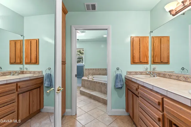 a bathroom with a sink a vanity and a mirror