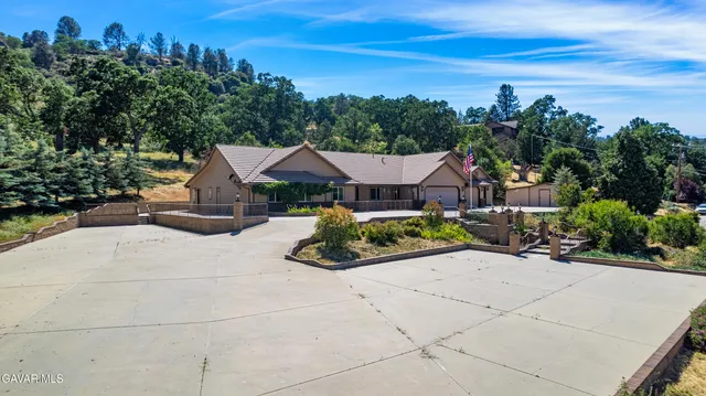 an aerial view of a house with swimming pool garden and outdoor seating