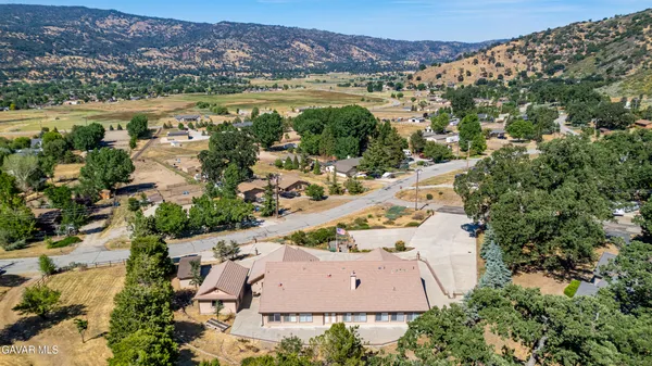 an aerial view of a house with a swimming pool