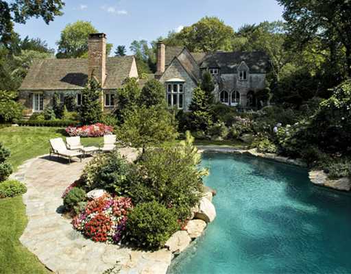 Undisclosed Address Greenwich, CT 06830 - Photo 1 of 10 a front view of a house with a yard and fountain