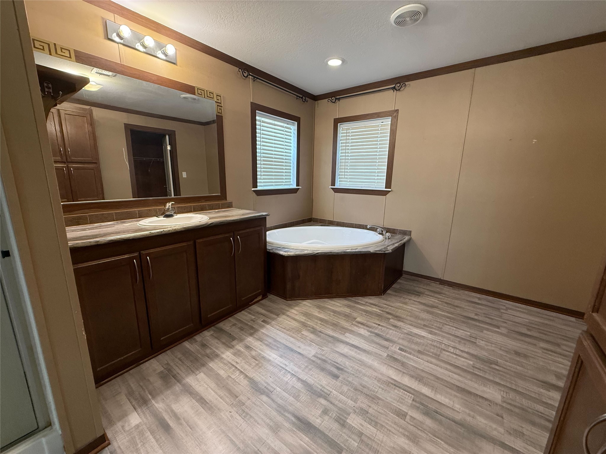 181 Janning Street Coldspring, TX 77331 - Photo 18 of 49 a spacious bathroom with a double vanity sink and a mirror