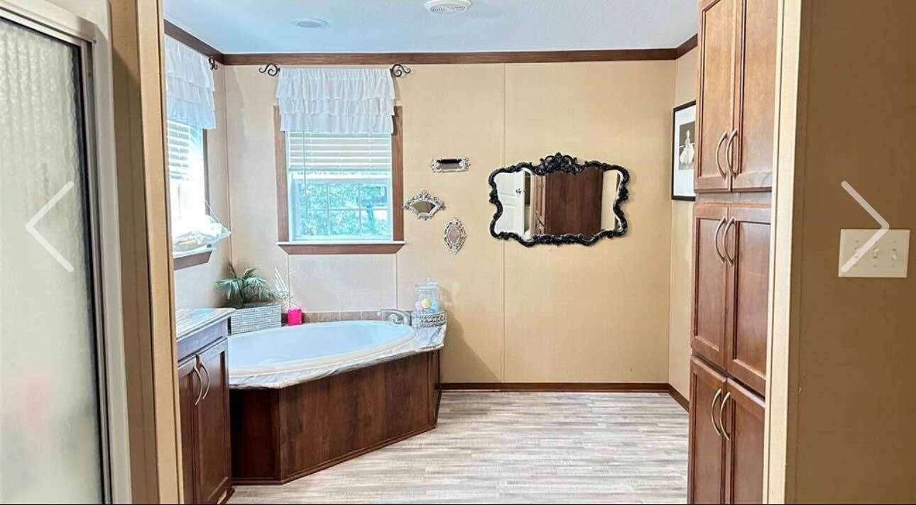 181 Janning Street Coldspring, TX 77331 - Photo 19 of 49 a bathroom with a sink and mirror with bathtub