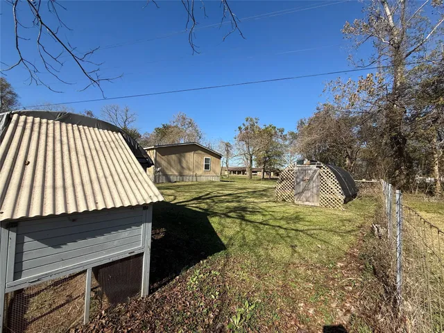 a view of a yard with cars