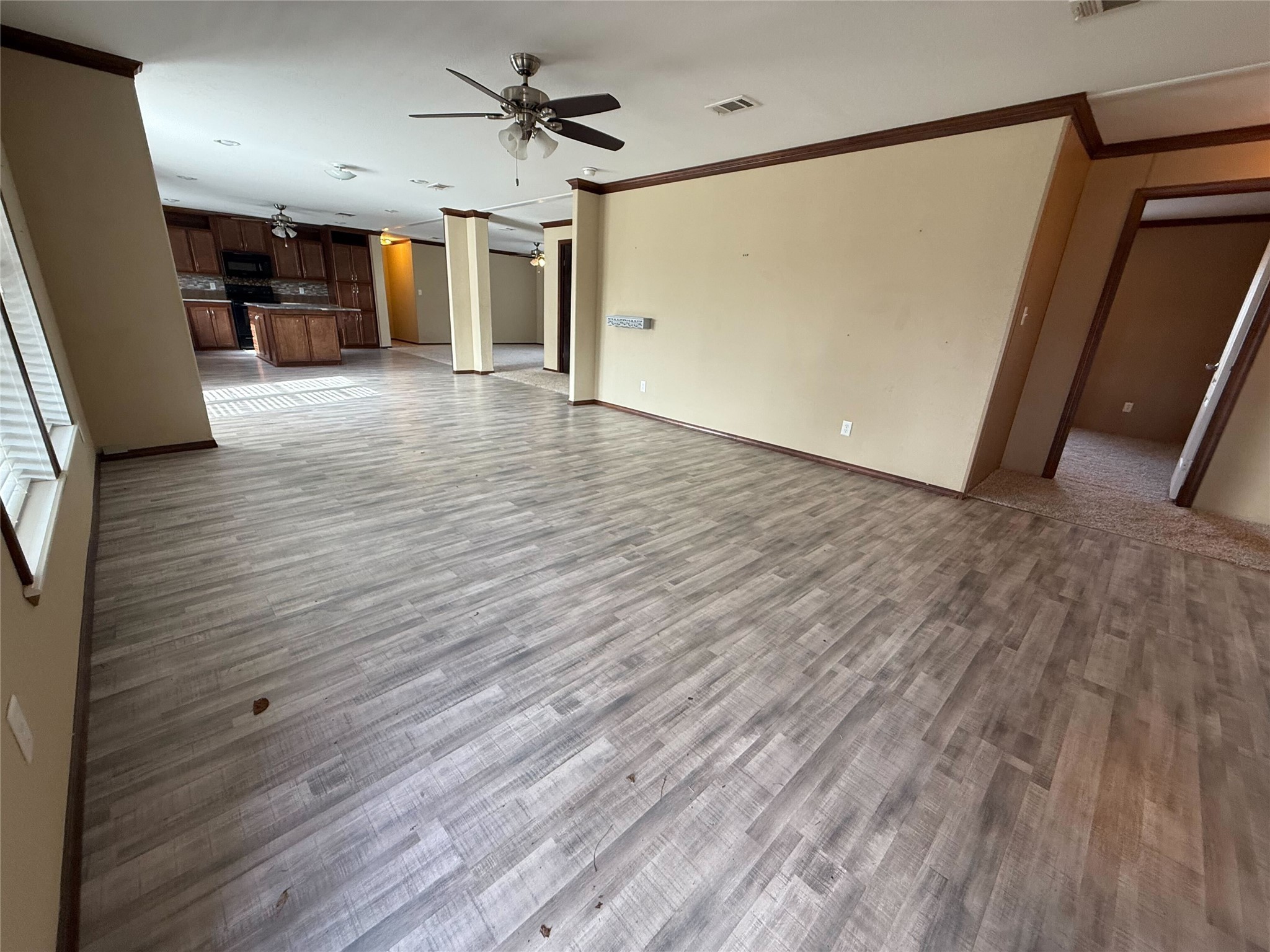 181 Janning Street Coldspring, TX 77331 - Photo 7 of 49 a view of a livingroom with wooden floor and a ceiling fan