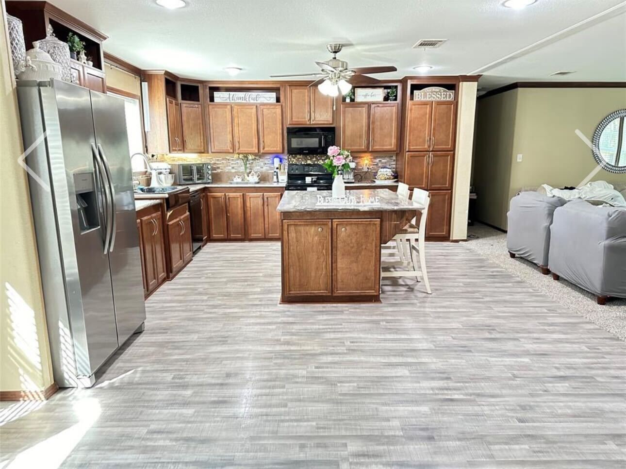 181 Janning Street Coldspring, TX 77331 - Photo 10 of 49 a kitchen with stainless steel appliances kitchen island granite countertop a refrigerator a stove top oven a sink and dishwasher