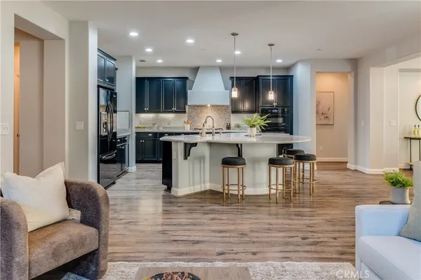 a kitchen with granite countertop a sink counter top space and stainless steel appliances