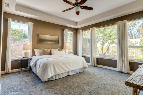 an empty room with closet and a ceiling fan