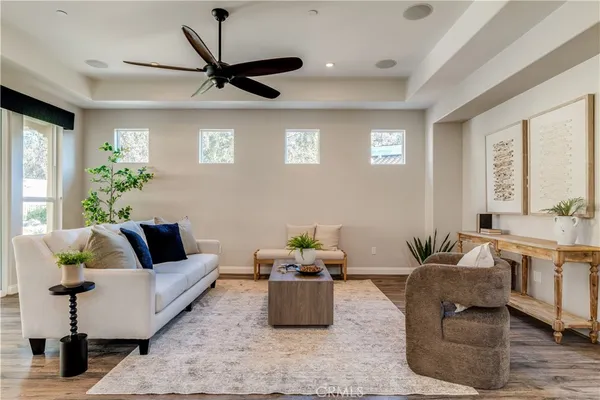 a living room kitchen with furniture and a wooden floor