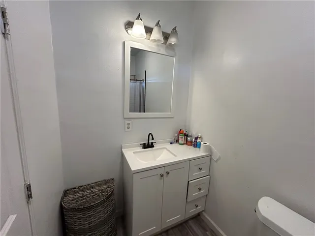 a bathroom with a sink toilet and mirror