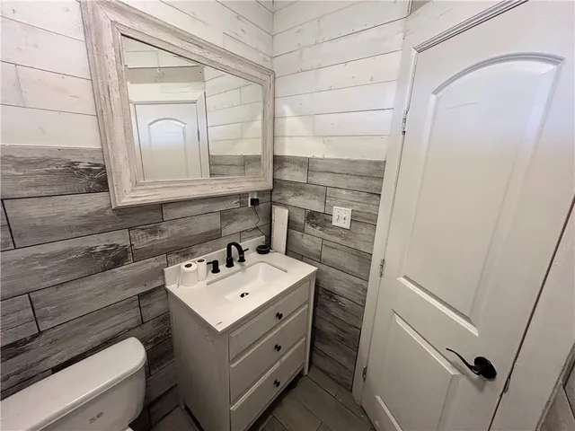 a bathroom with a sink mirror and vanity