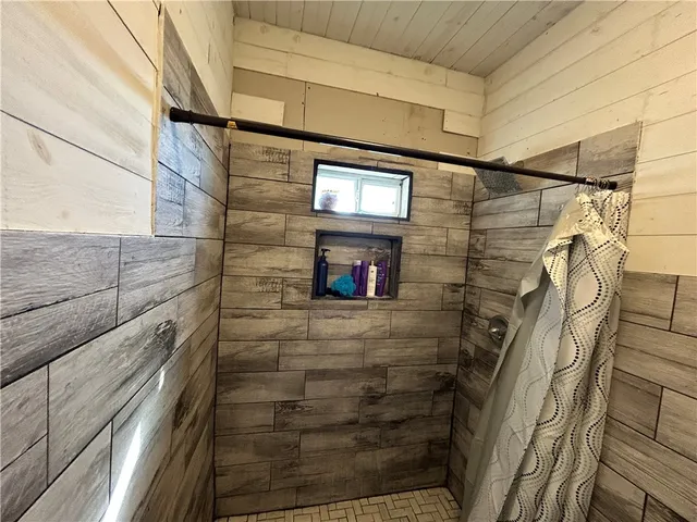 a bathroom with a shower and a sink