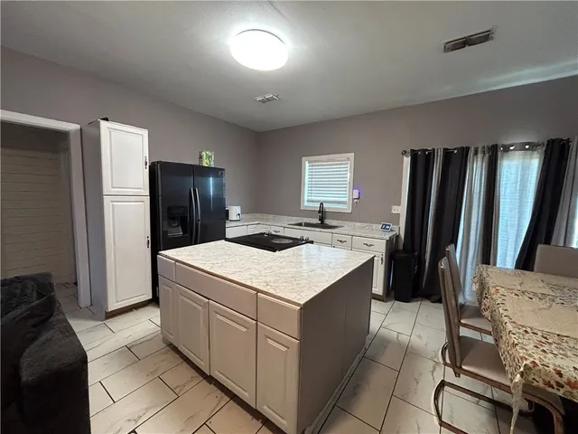 a kitchen that has a cabinets and a refrigerator