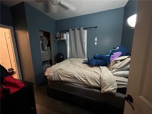 a bedroom with a bed and a mirror