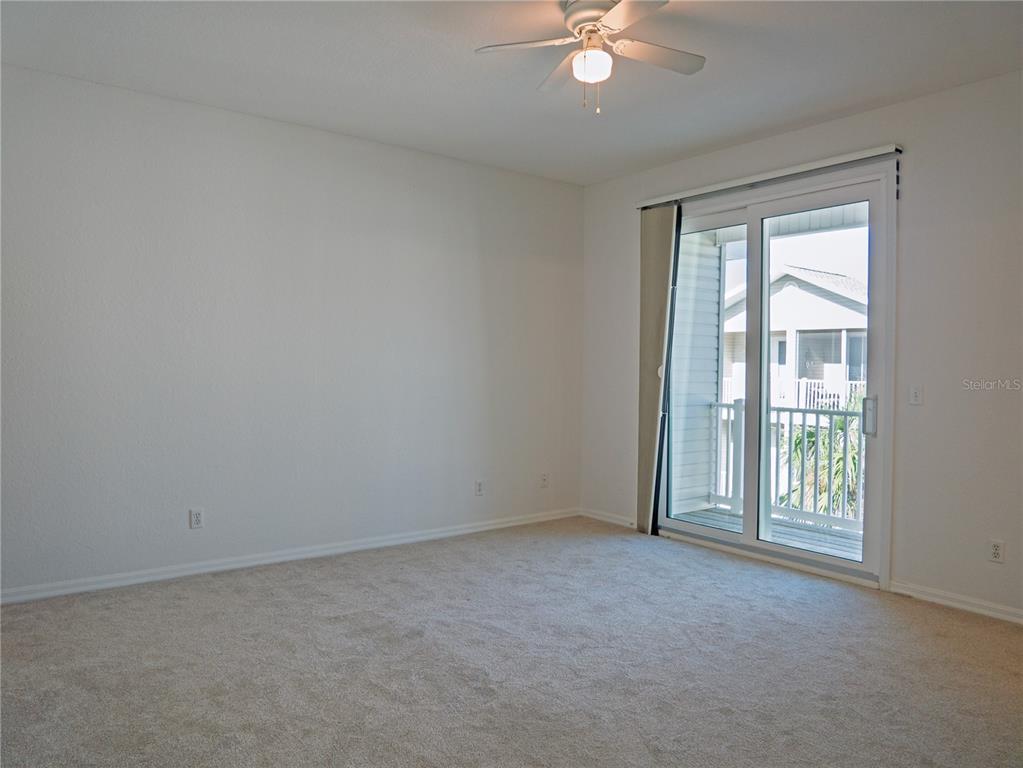 15473 Gulf Boulevard Madeira Beach, FL 33708 - Photo 15 of 40 an empty room with chandelier fan