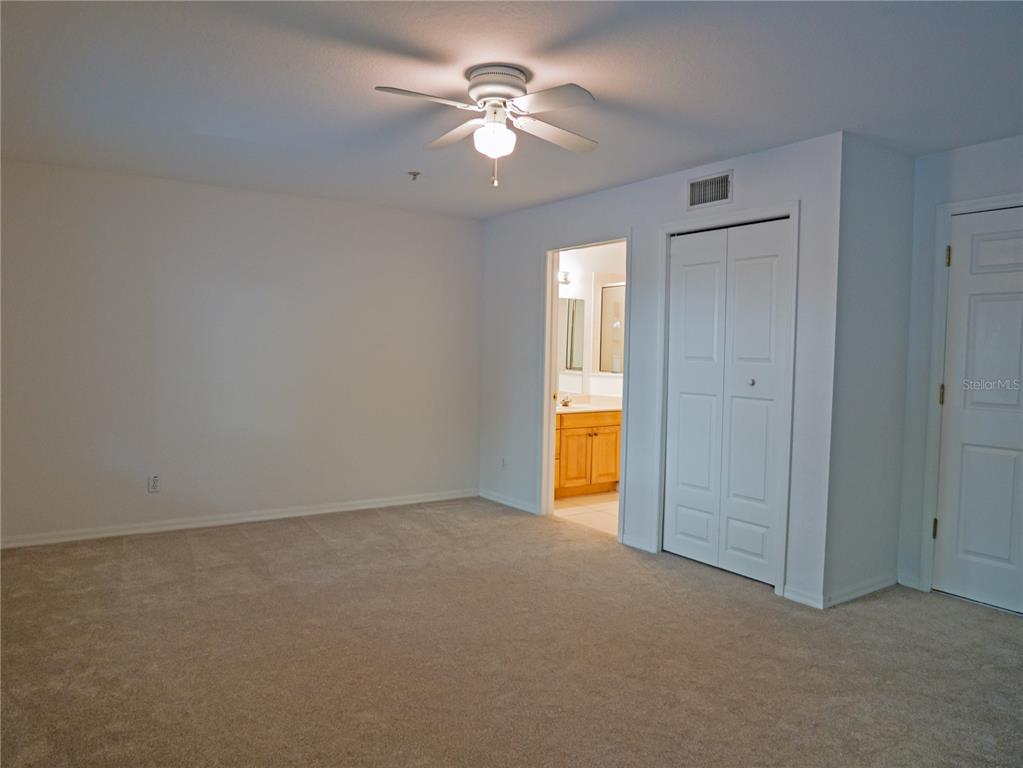 15473 Gulf Boulevard Madeira Beach, FL 33708 - Photo 26 of 41 an empty room with a ceiling fan and a window