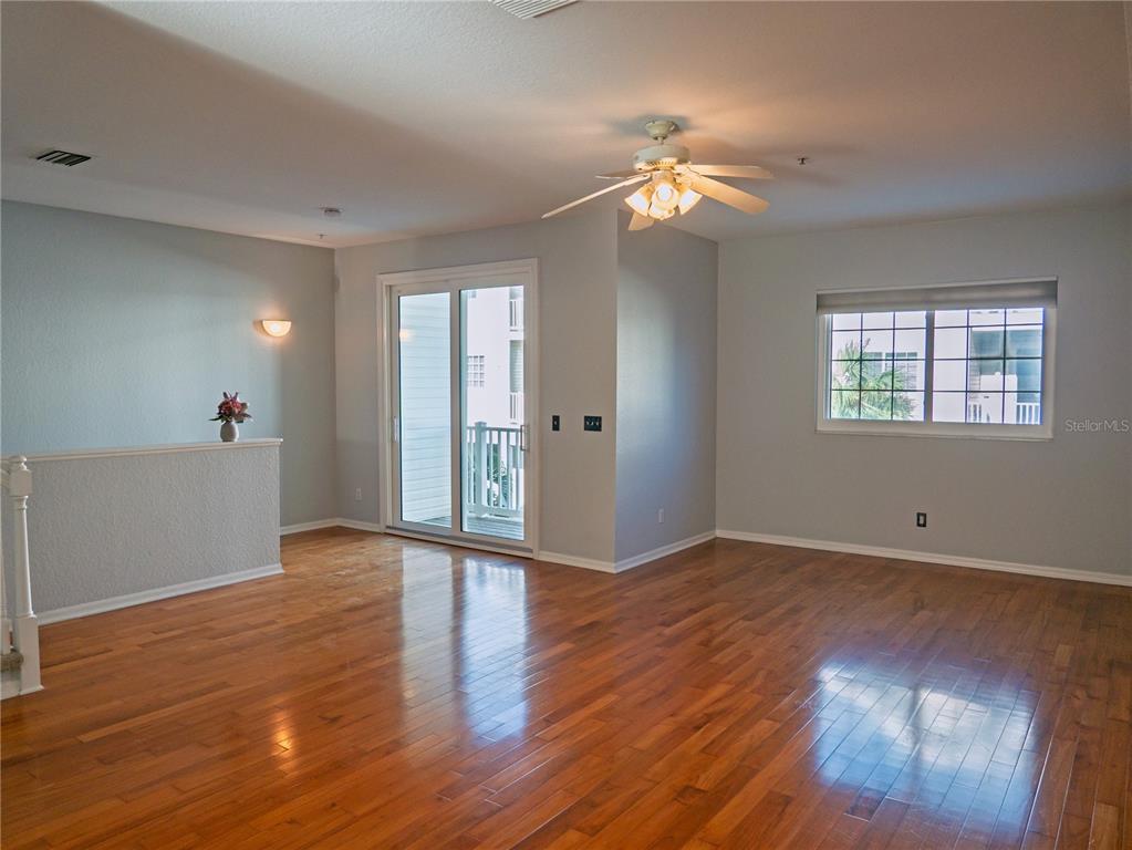 15473 Gulf Boulevard Madeira Beach, FL 33708 - Photo 5 of 40 a view of an empty room with wooden floor and a window