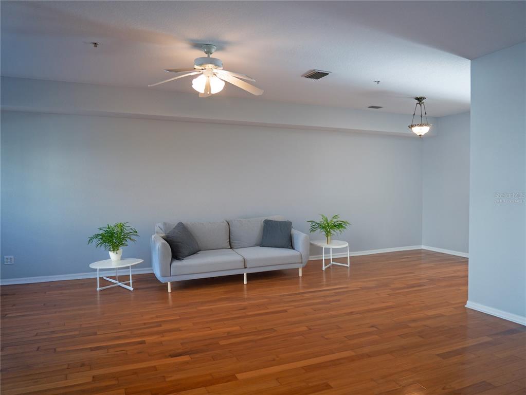 15473 Gulf Boulevard Madeira Beach, FL 33708 - Photo 6 of 41 a living room with furniture and wooden floor