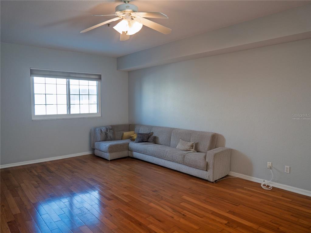 15473 Gulf Boulevard Madeira Beach, FL 33708 - Photo 8 of 41 a living room with furniture and a wooden floor