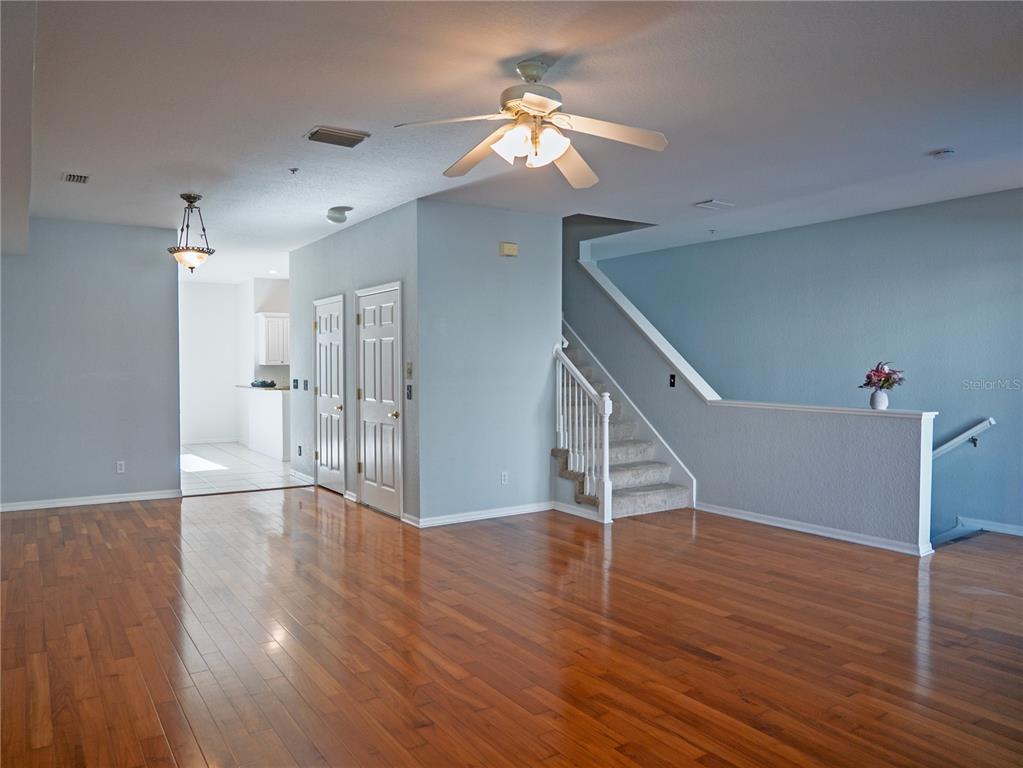 15473 Gulf Boulevard Madeira Beach, FL 33708 - Photo 10 of 41 a view of an empty room with wooden floor and a ceiling fan