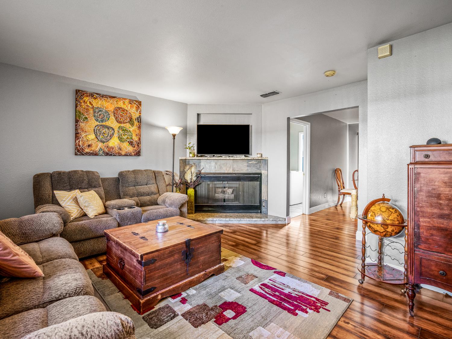 5324 Garfield Avenue, Unit 3 Sacramento, CA 95841 - Photo 6 of 17 a living room with furniture a flat screen tv and a fireplace