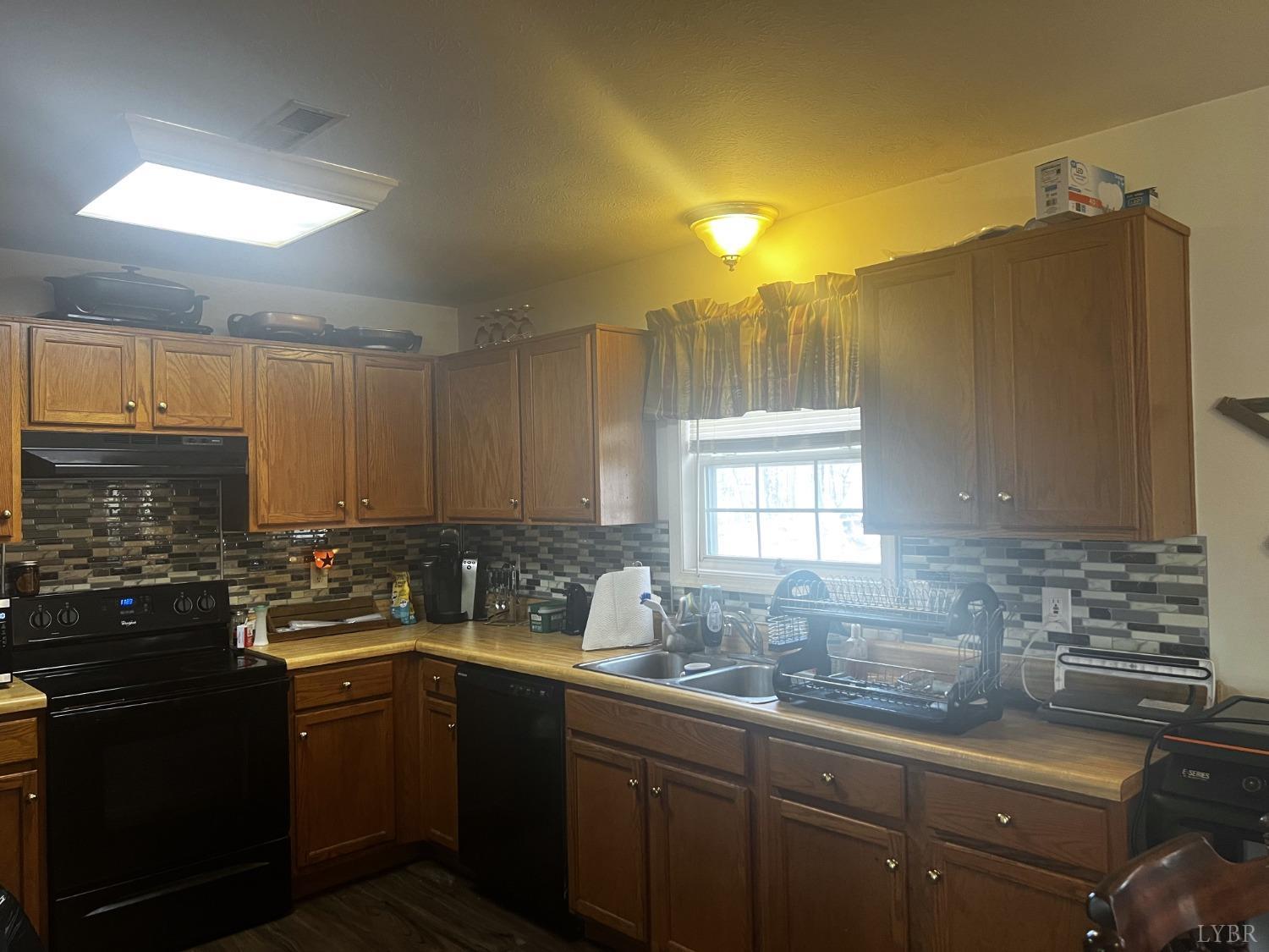 12098 Scuffletown Road Randolph, VA 23962 - Photo 3 of 30 a kitchen with a sink a counter space and cabinets