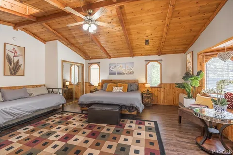 a bedroom with furniture and wooden floor