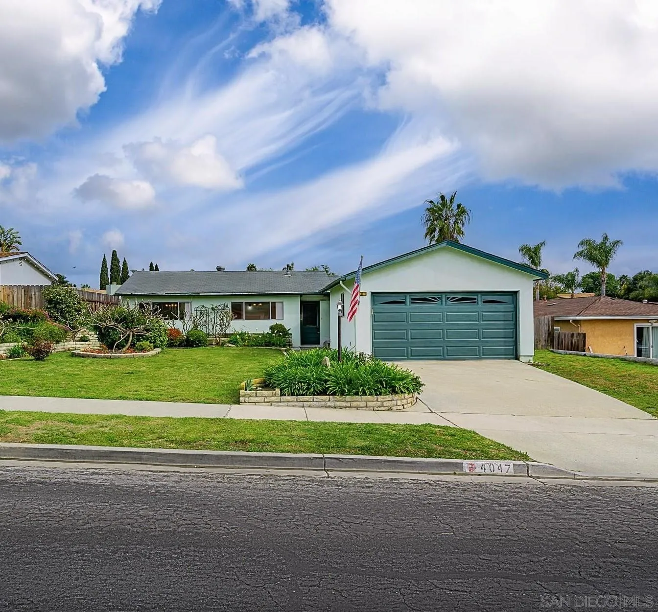 4047 Thomas Street Oceanside, CA 92056 - Photo 1 of 21 a front view of a house with a yard and garage