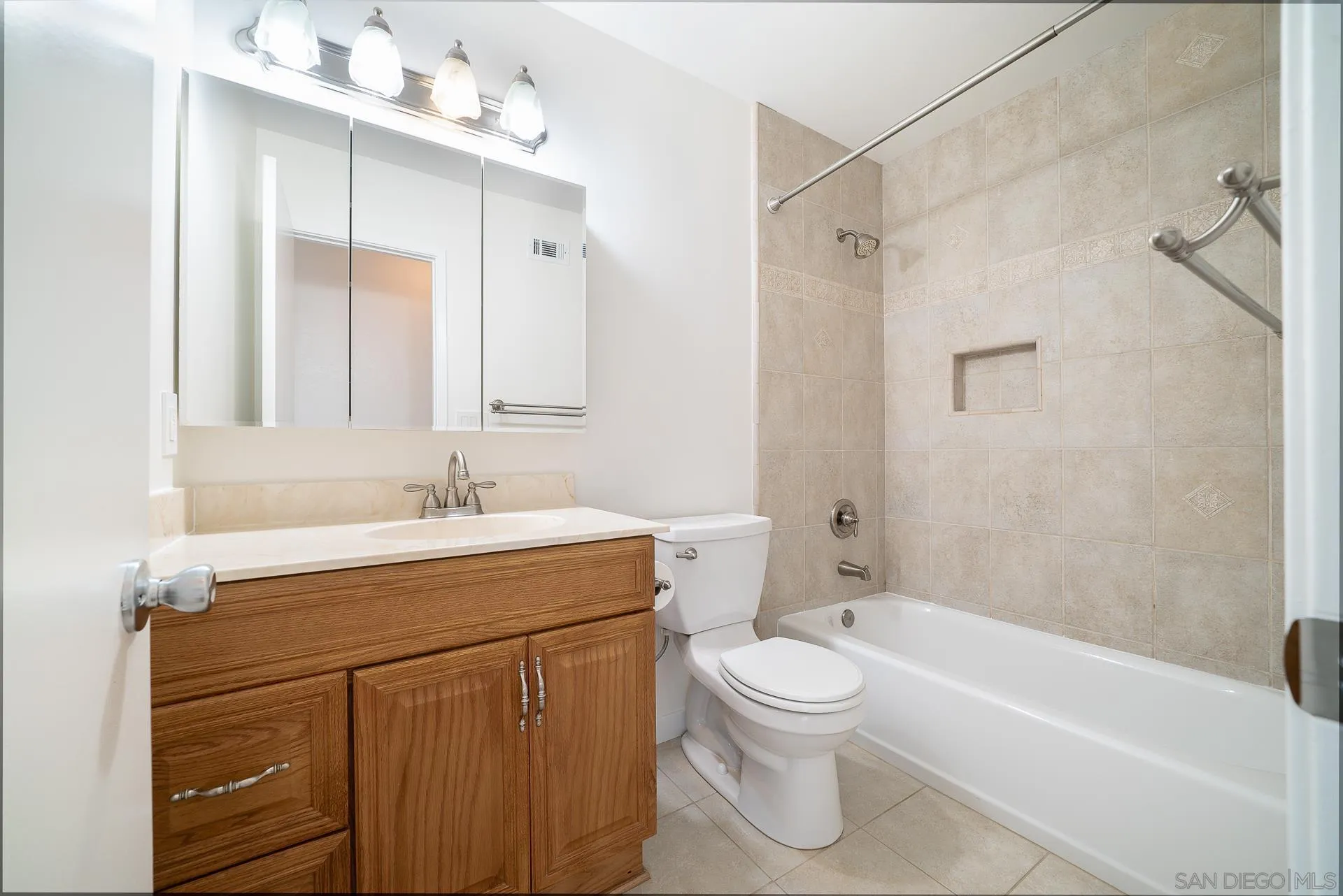 4047 Thomas Street Oceanside, CA 92056 - Photo 15 of 21 a bathroom with a toilet a sink a mirror a bathtub and vanity