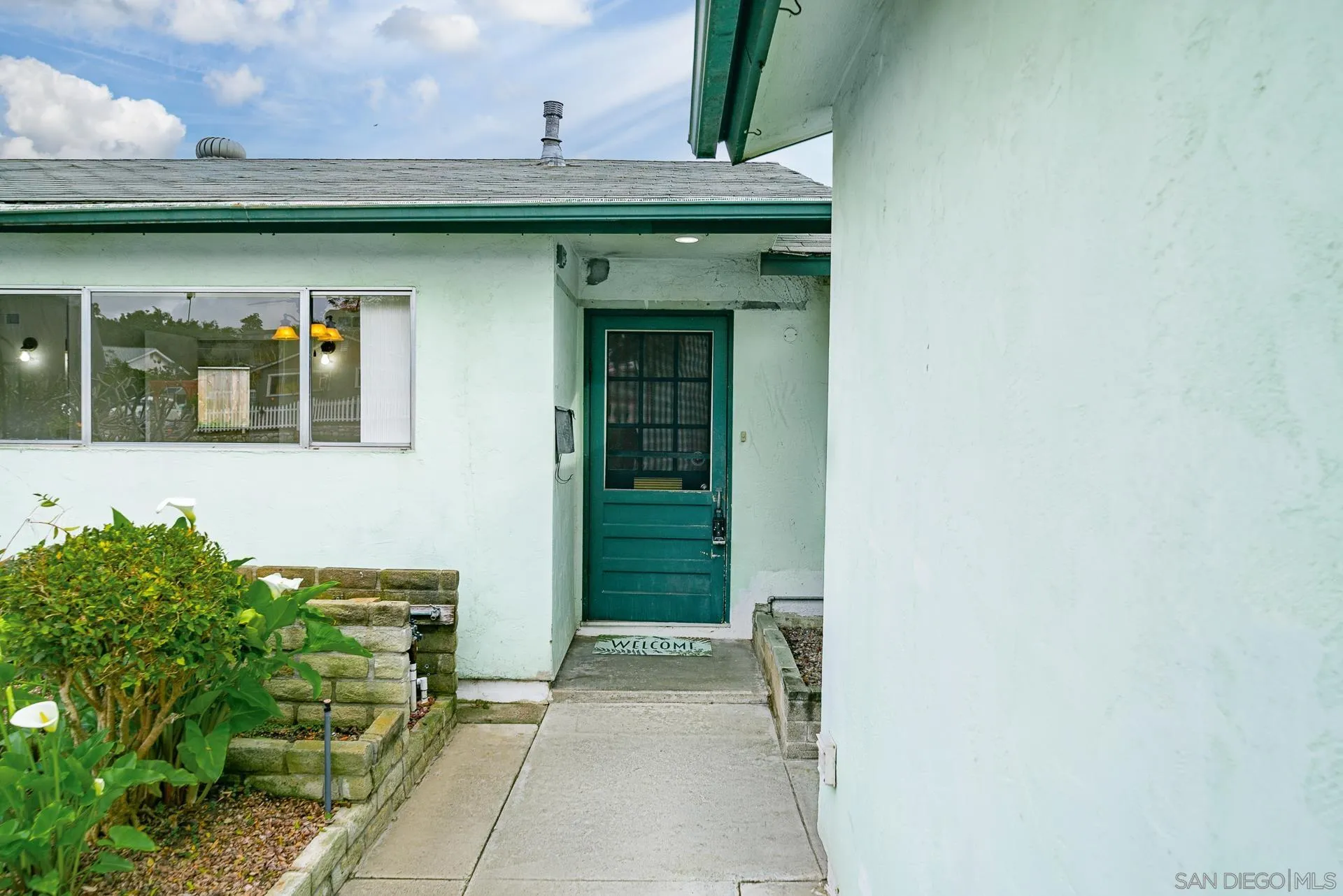 4047 Thomas Street Oceanside, CA 92056 - Photo 4 of 21 a front view of a house with a garden