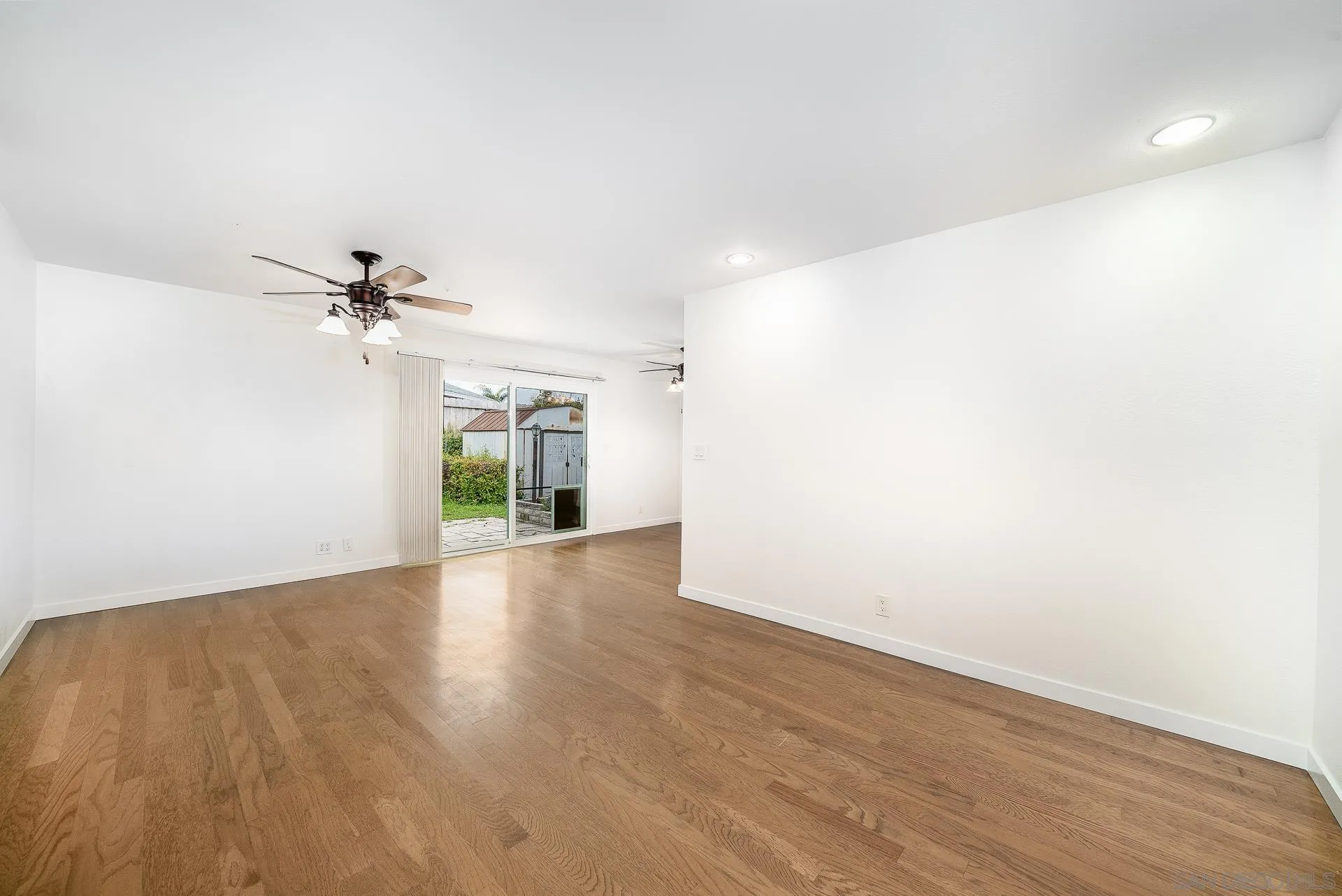 4047 Thomas Street Oceanside, CA 92056 - Photo 6 of 21 a view of a room with wooden floor and a ceiling fan