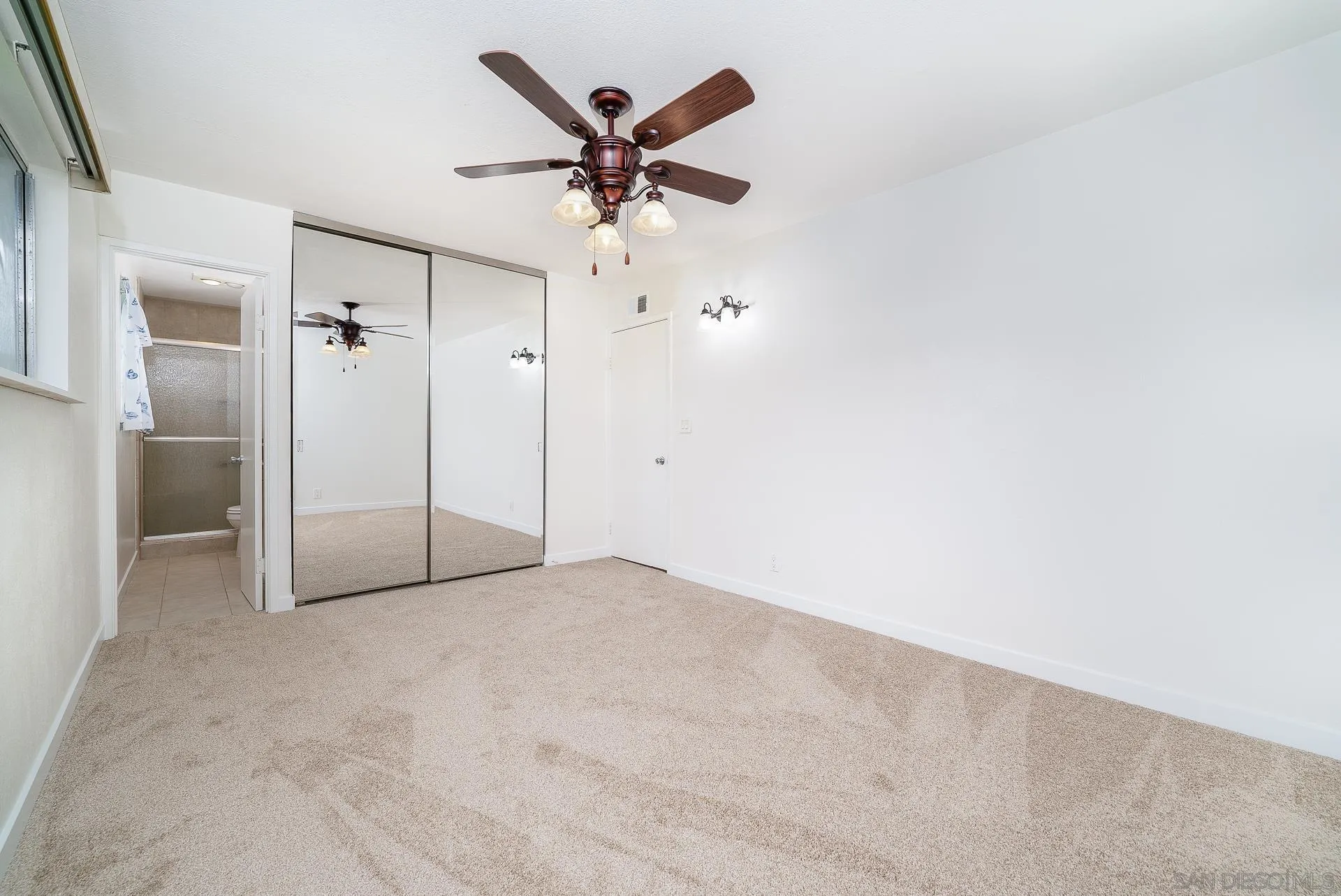 4047 Thomas Street Oceanside, CA 92056 - Photo 9 of 21 an empty room with a ceiling fan and a window
