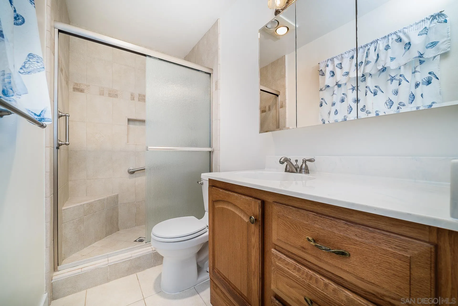 4047 Thomas Street Oceanside, CA 92056 - Photo 10 of 21 a bathroom with a sink a toilet and shower