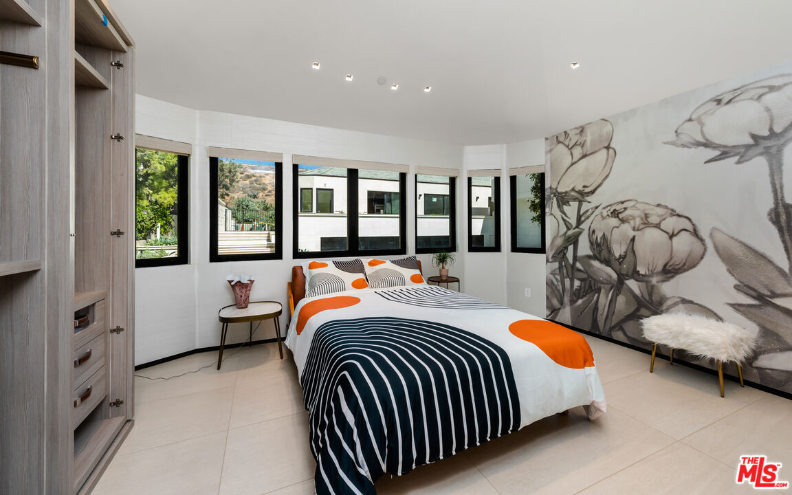 31100 Broad Beach Road Malibu, CA 90265 - Photo 22 of 38 a bed room with a bed and a chair