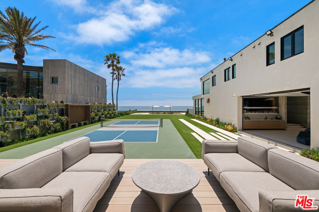 31100 Broad Beach Road Malibu, CA 90265 - Photo 29 of 38 a view of a patio with couches chairs and a fire pit
