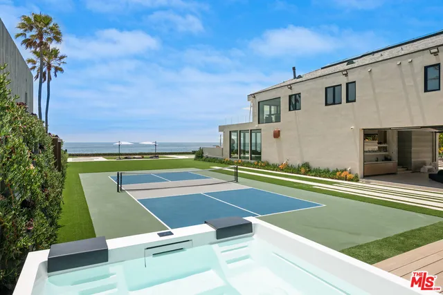 a view of a swimming pool and lounge chairs