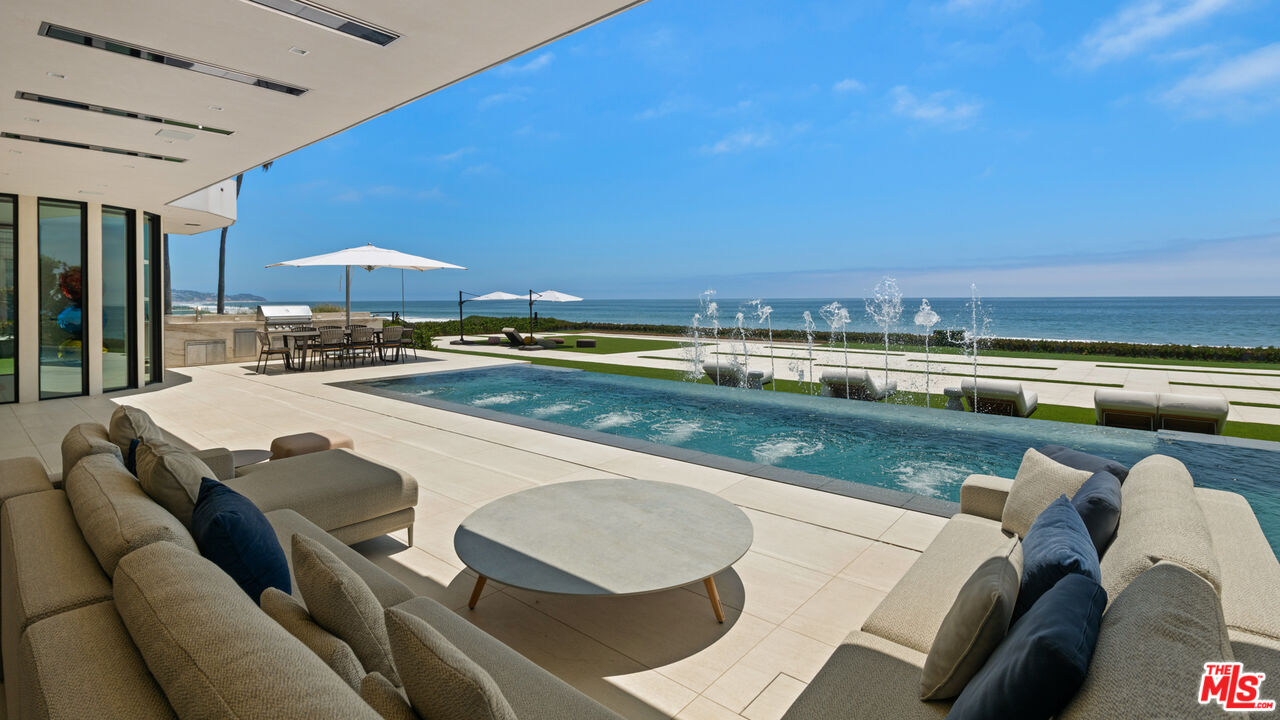 31100 Broad Beach Road Malibu, CA 90265 - Photo 33 of 38 a view of a swimming pool and lounge chairs