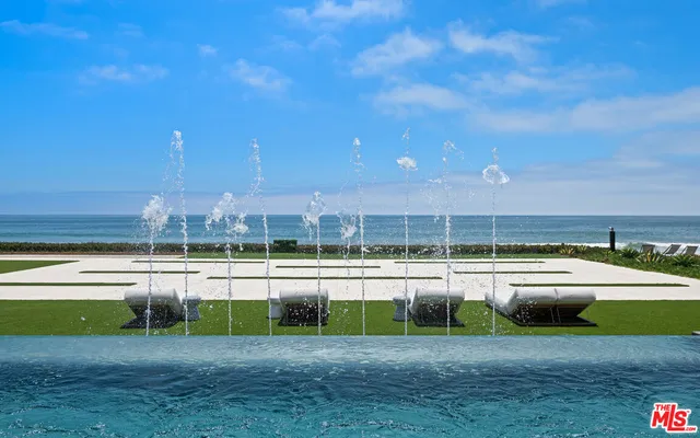 a view of a house with swimming pool and sitting area