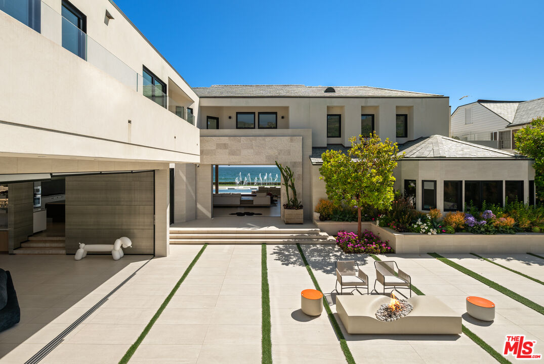 31100 Broad Beach Road Malibu, CA 90265 - Photo 5 of 38 a view of a patio with table and chairs potted plants with wooden floor