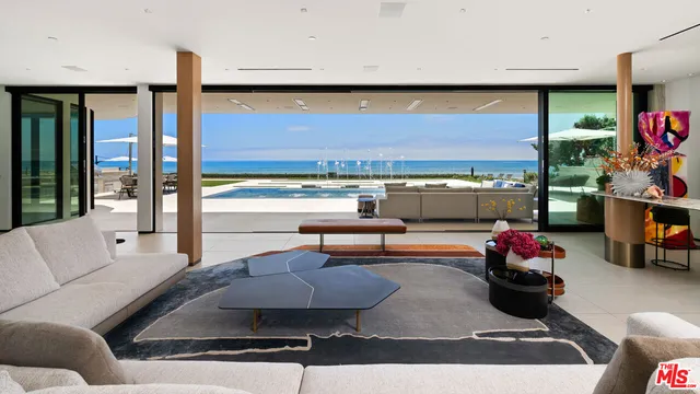 a very nice looking living room with furniture and a large window